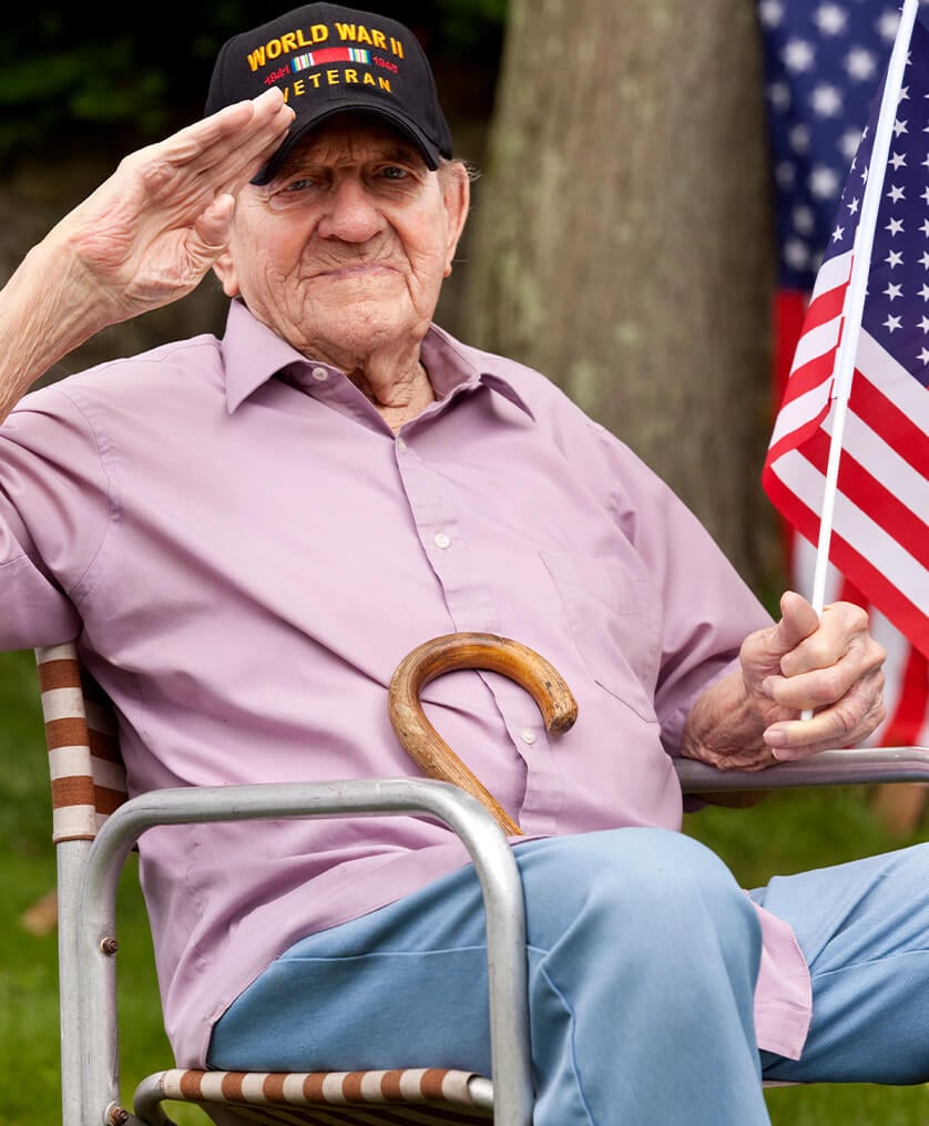 veteran sitting with flag